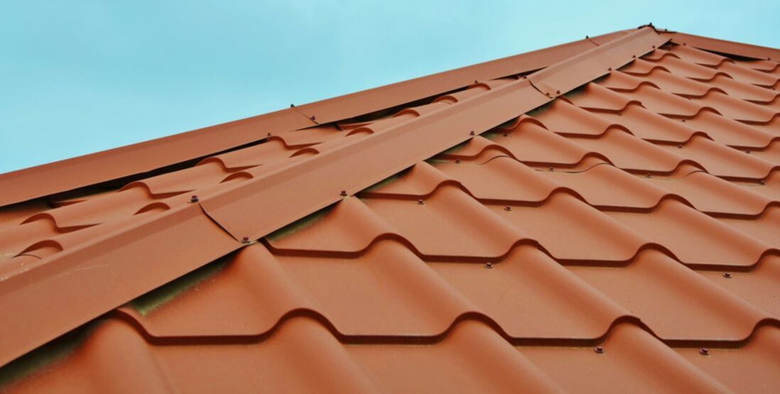 Close up image of a new, rust-color metal roof
